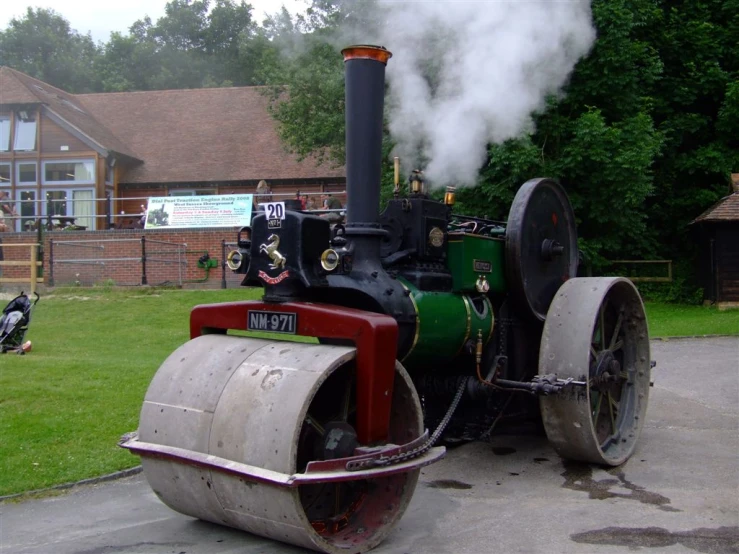 the old locomotive with a steam engine is traveling around the grounds