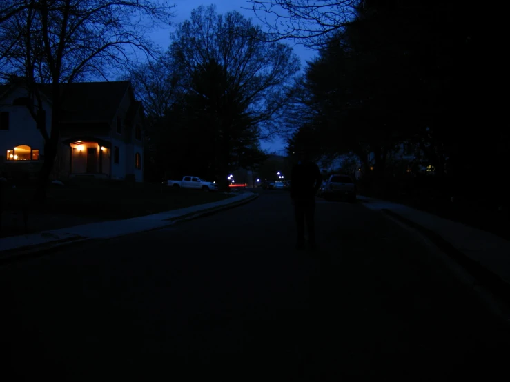 a person walking along a city street at night