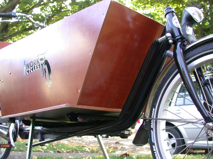 an old, large trunk and suitcase on a bicycle