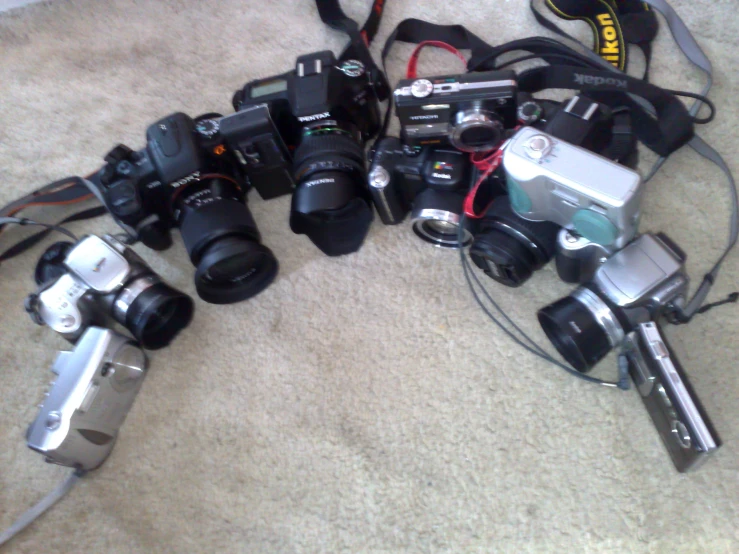 many different cameras sitting on the ground