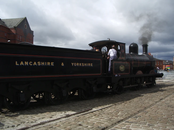 the man stands on the carton of an antique train