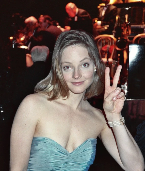 a women posing for the camera with her peace sign