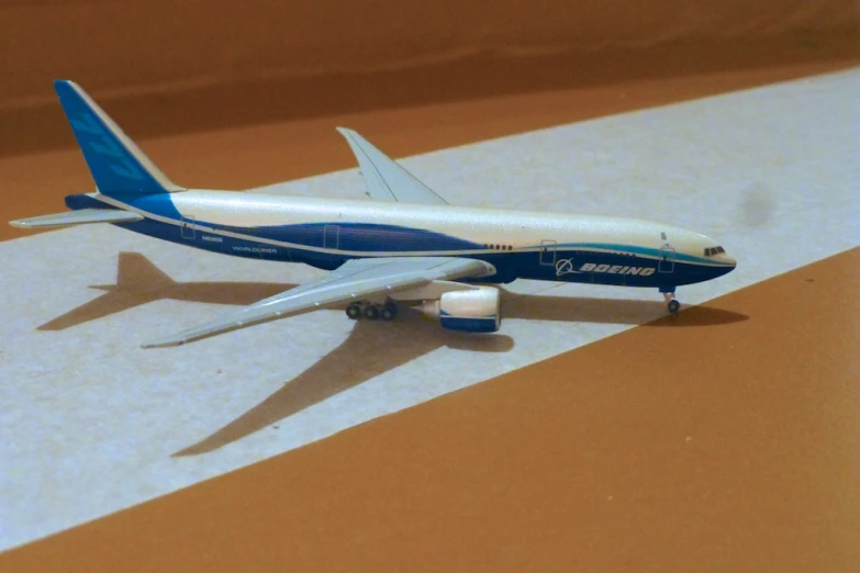 a toy airplane on a countertop with a brown background