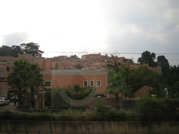 a large brick building next to a forest