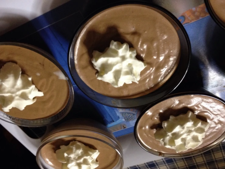 a bunch of chocolate desert pies on a table