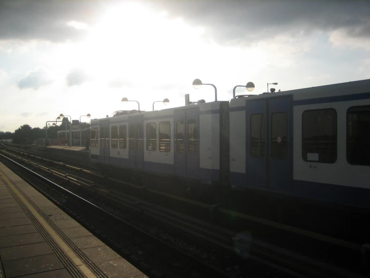 a passenger train parked on the tracks in the day