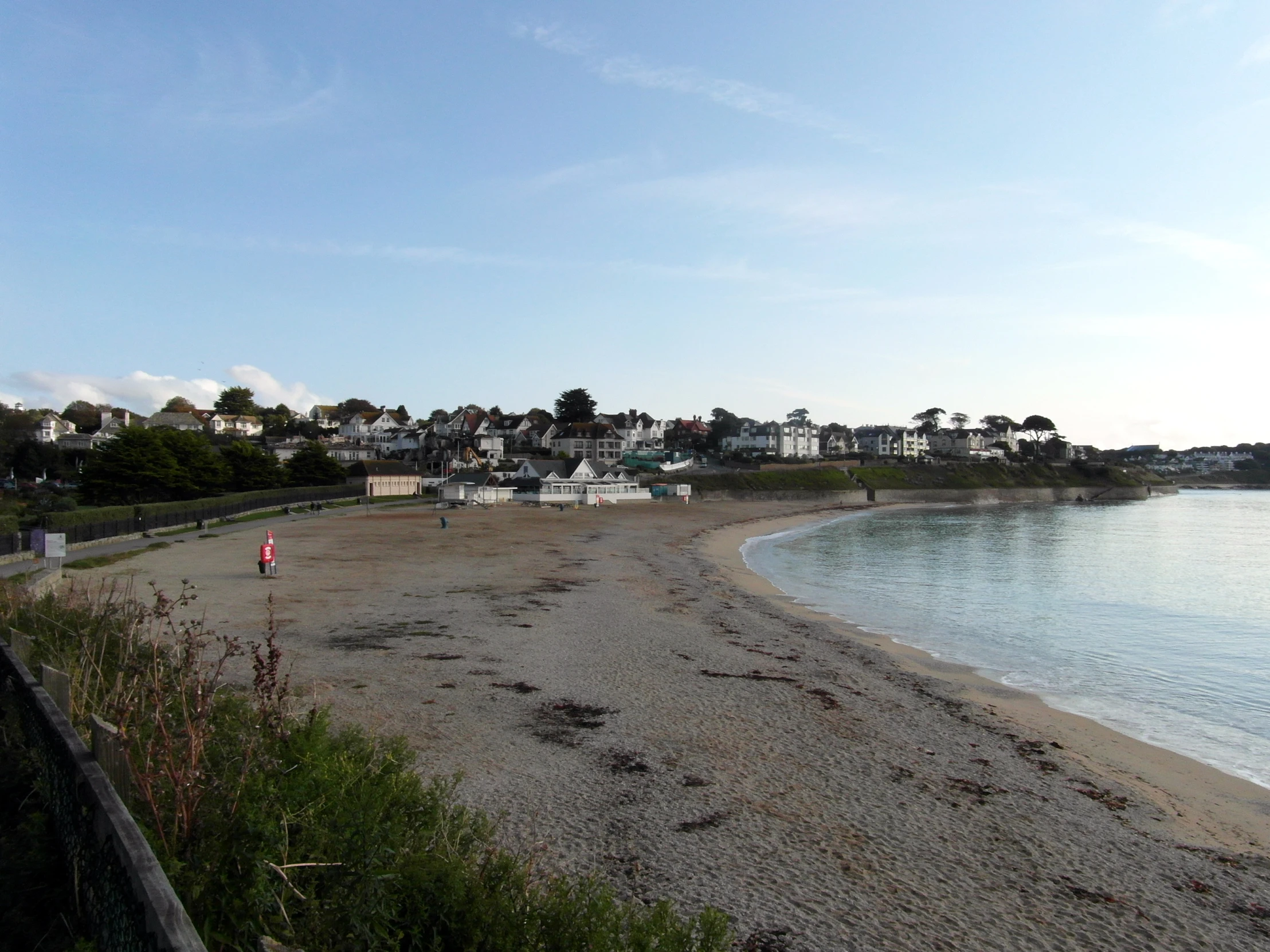 a beach with many buildings near the shore