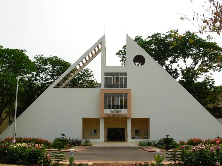 a triangle shape building with stairs leading up to it