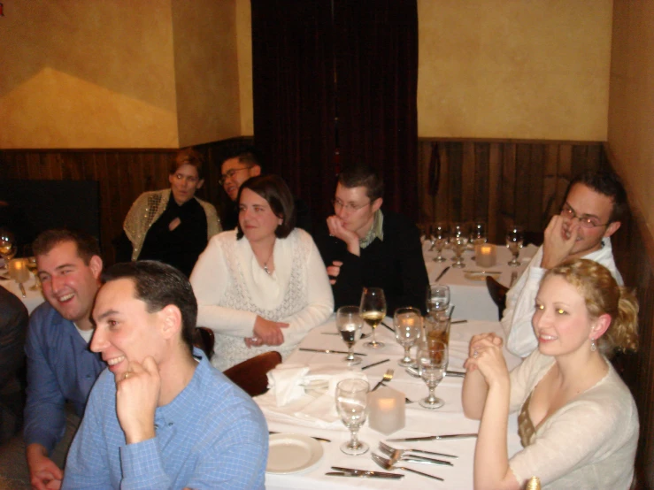 people are seated around a table in a restaurant