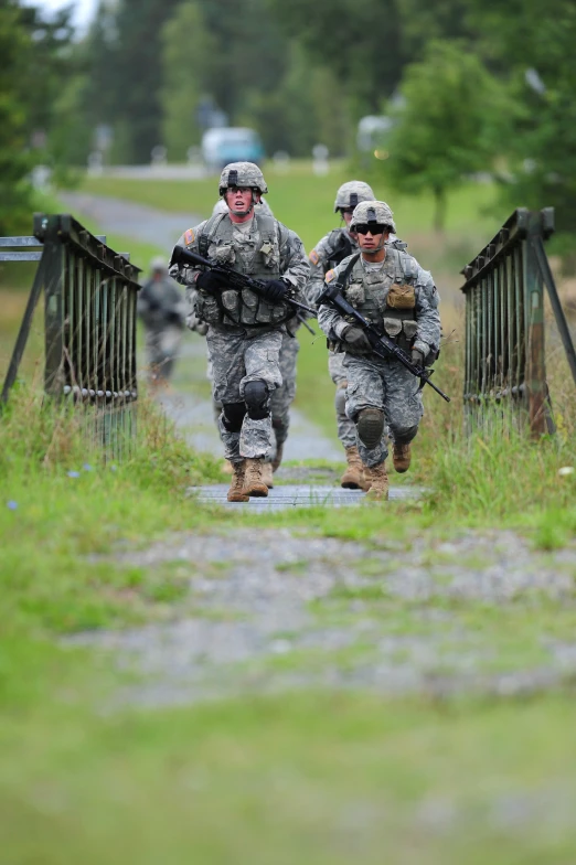 two soldiers with guns on a small bridge