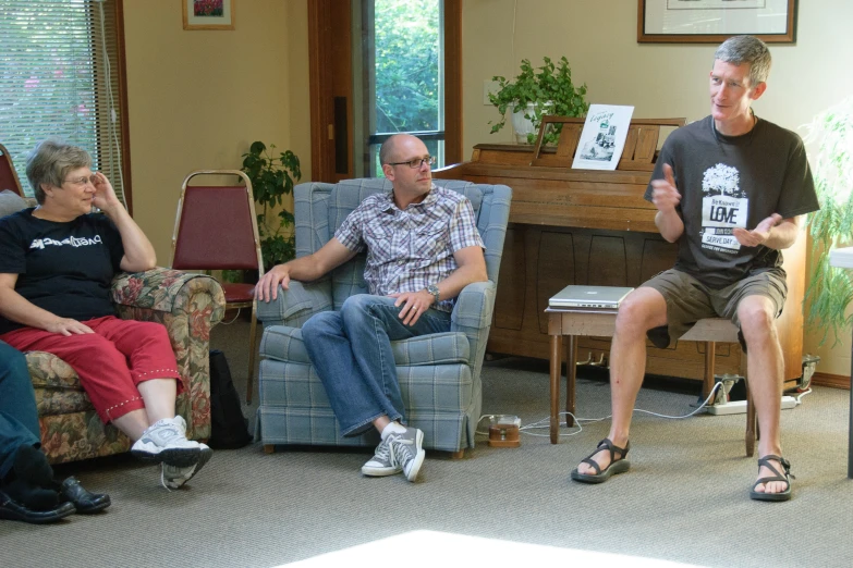 a family sits in a living room playing wii