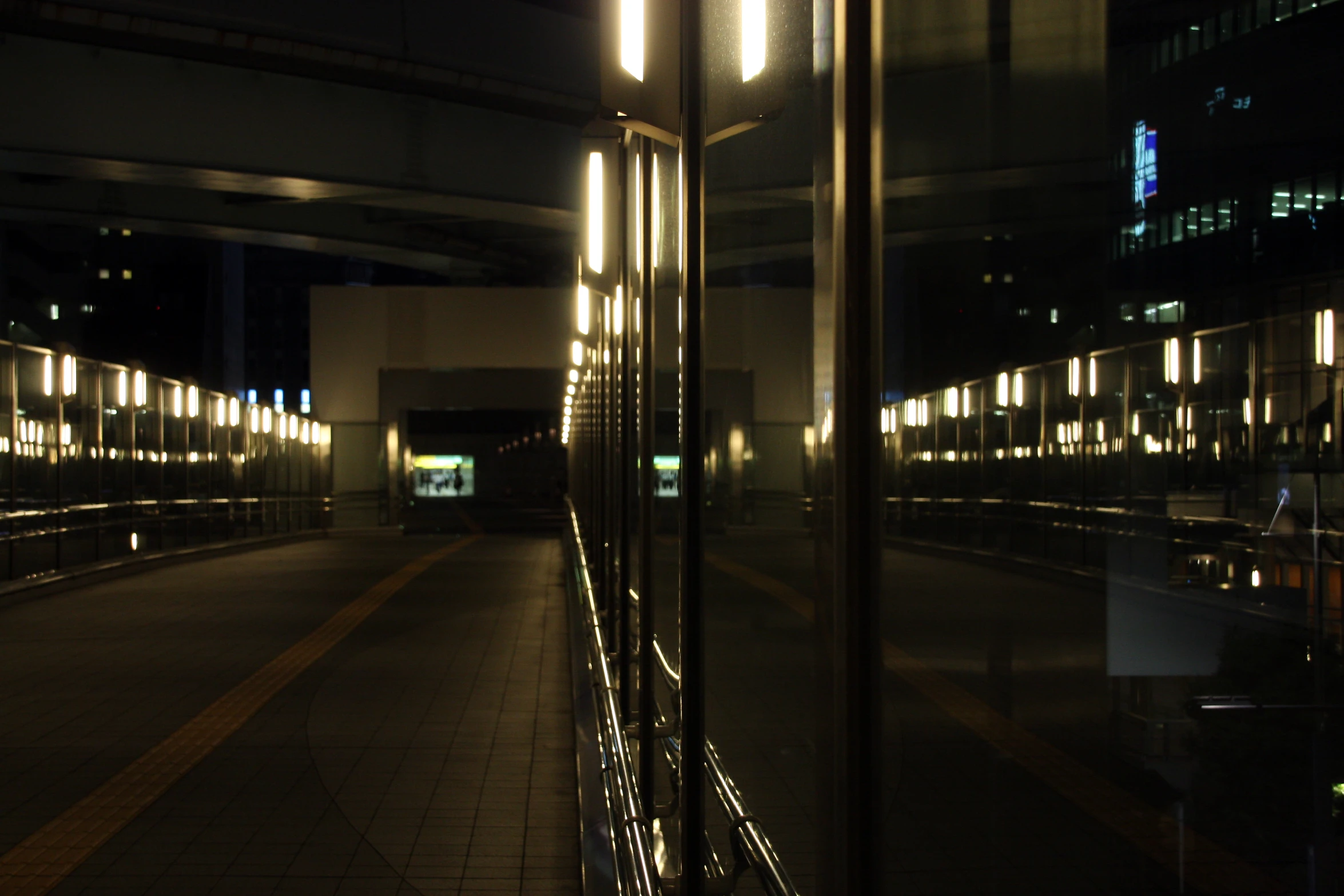 looking out the window of a train station at night