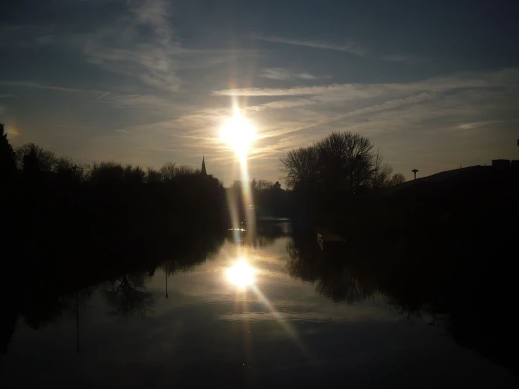 sun going down over a body of water