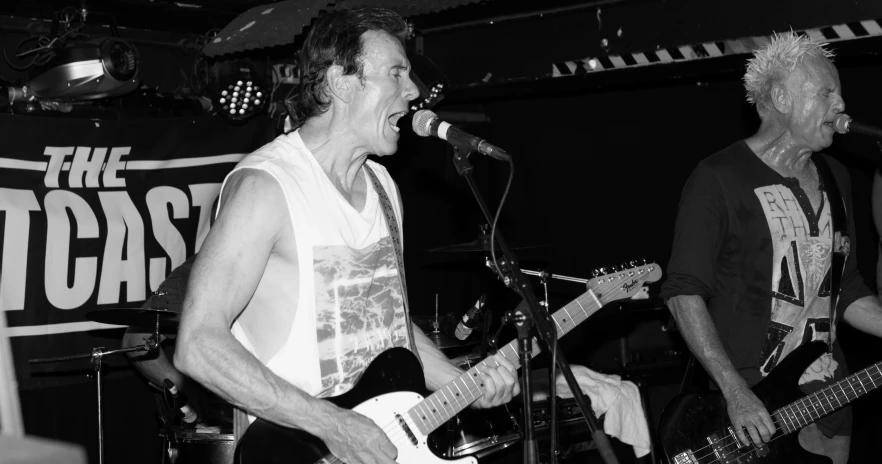 black and white po of two men playing guitars