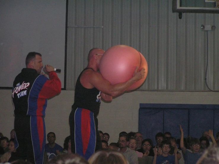 a couple of men are standing in front of a crowd