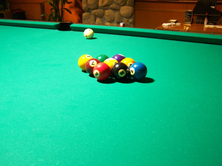 eight ball balls lined up on a green pool table