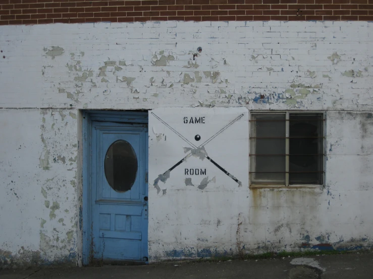 a wall with a door and sign on it