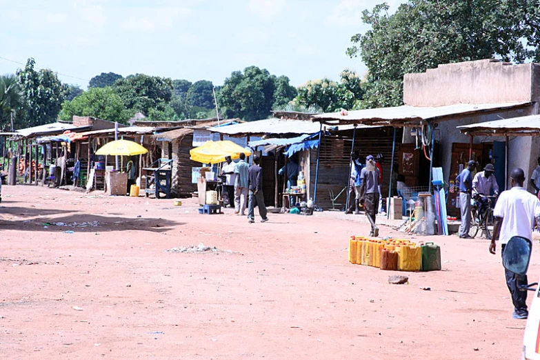 people are walking through the street in front of some buildings