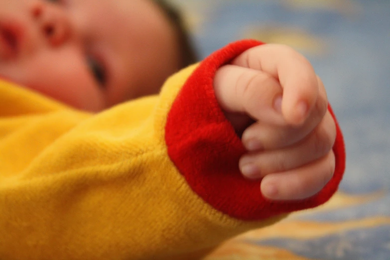 a small child is pointing their finger and is smiling