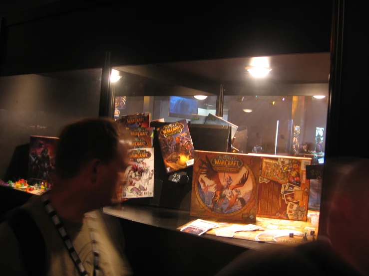 a group of people standing around tables filled with comics