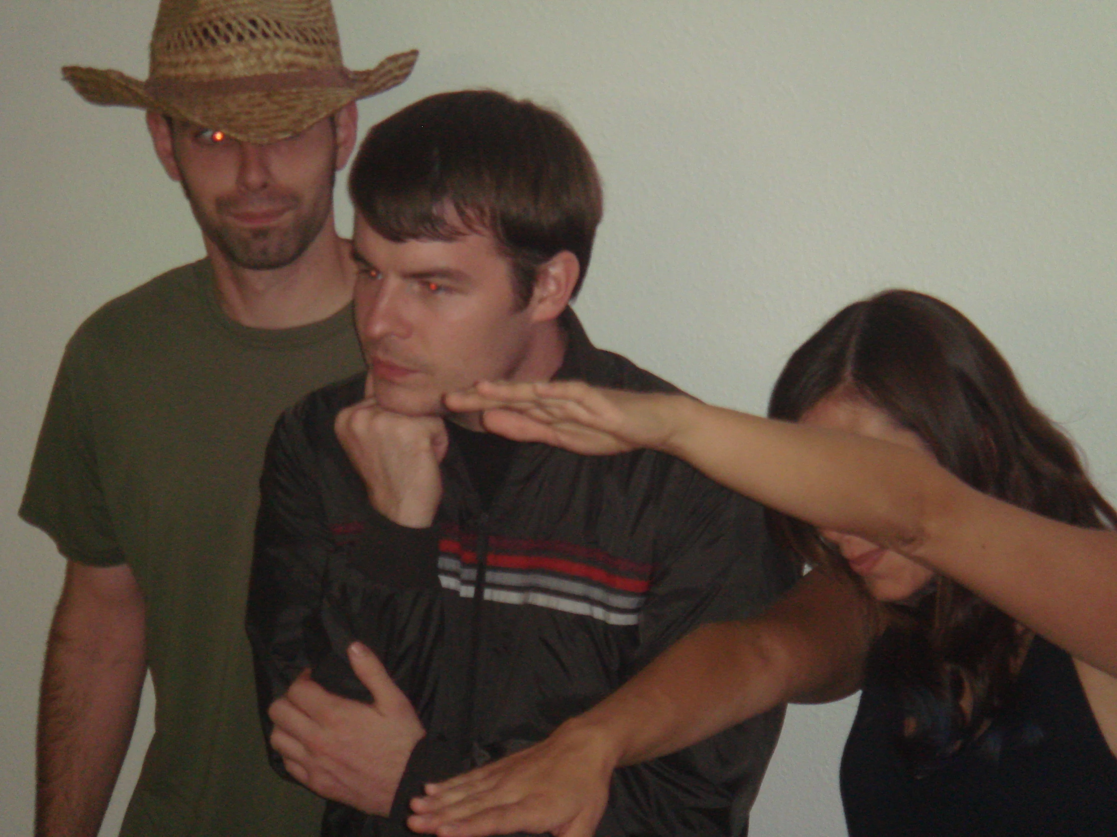 three young people with hats standing around looking at the camera