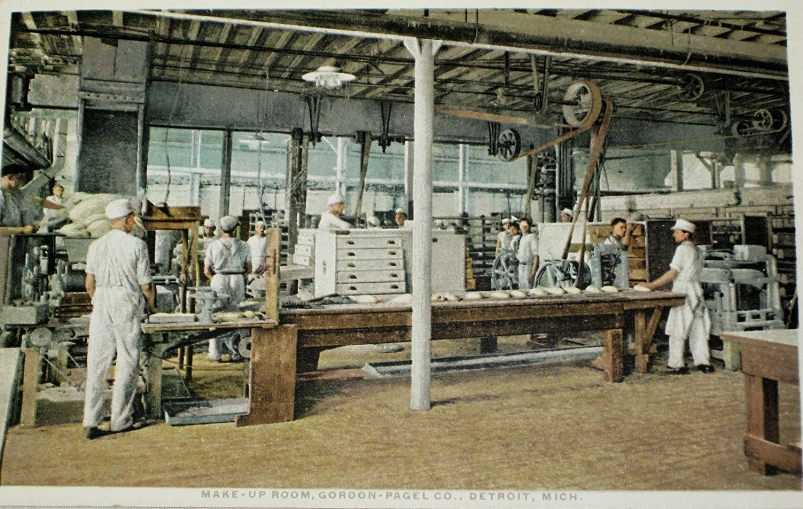 some people standing around a table working on pieces of equipment