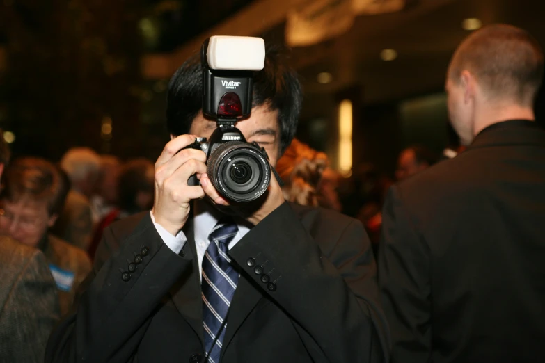 a man with a camera on his head, holding his thumb up