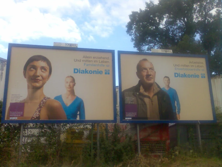 a couple of billboards displaying some people on them