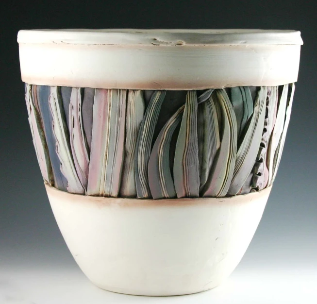 a vase is painted with thin strips of pastel colors