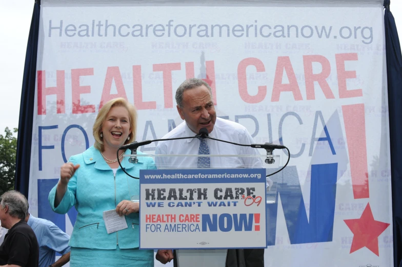 two people holding microphones at a health care campaign