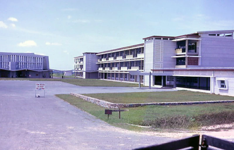 a school building with parking lot and walkways