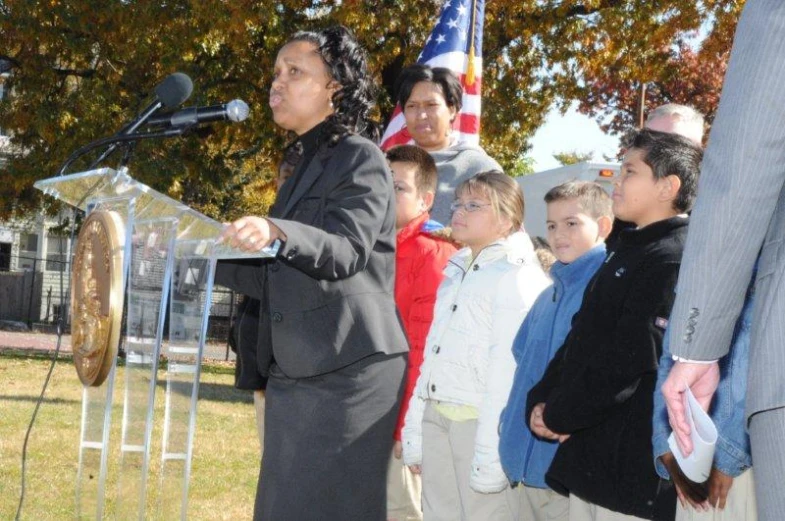 man standing behind a podium giving a speech