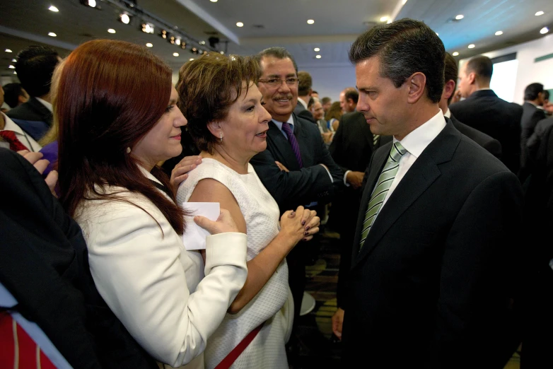 two woman in white and a man in black are having fun