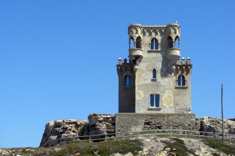 the top of a castle with tall windows