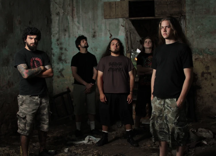 several men stand against a wall and look up