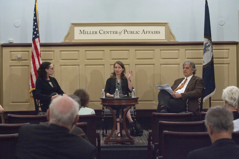 a panel discussion is being held in front of many people