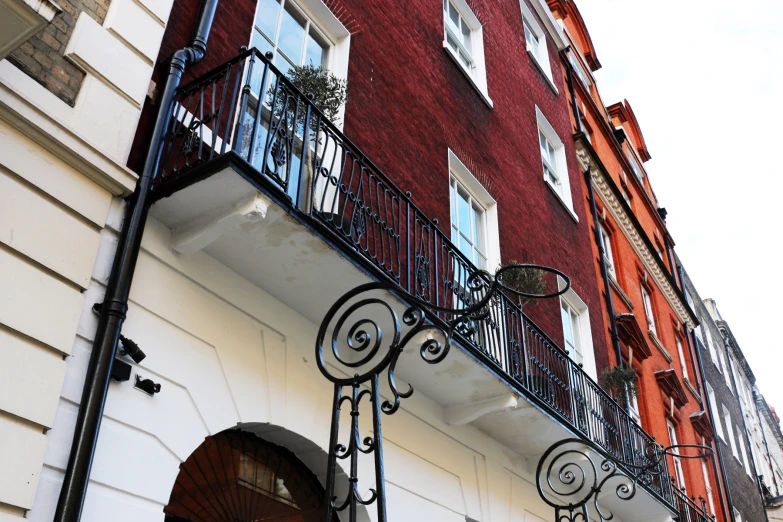 there are many windows and metal railings on this building