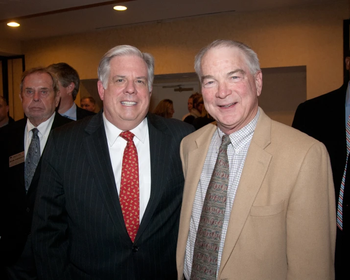 two men are wearing neck ties and suits