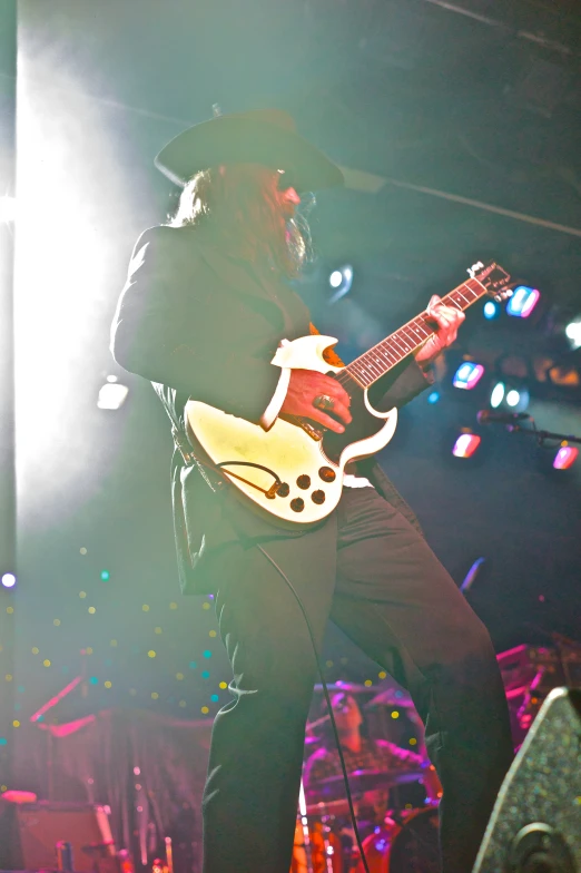 guitarist playing guitar while lit by bright spotlights