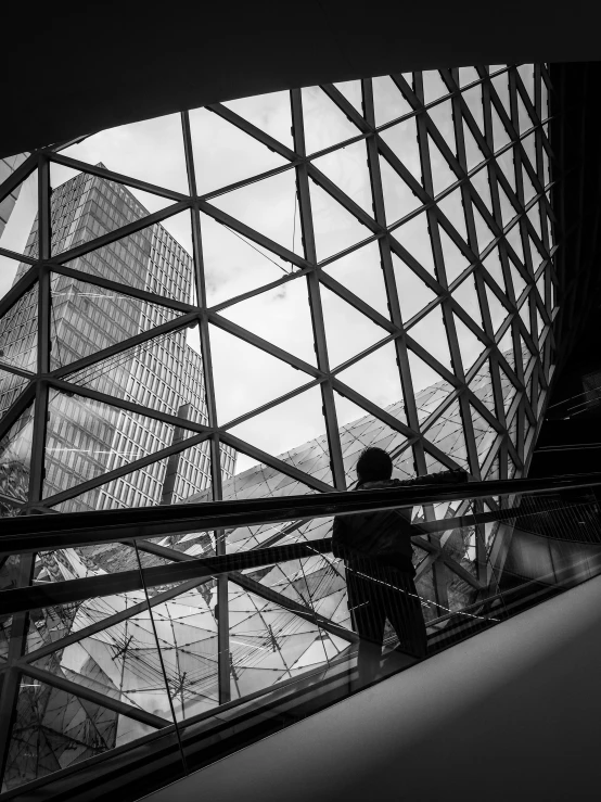 person on escalator at city hall in hong kong