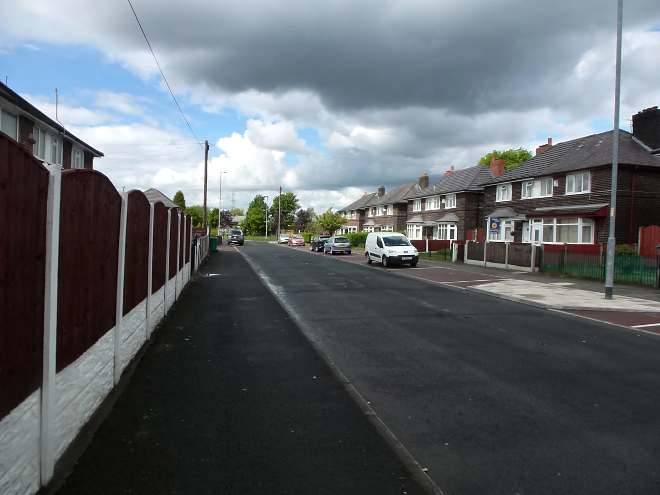 a street is lined with brick buildings, and houses