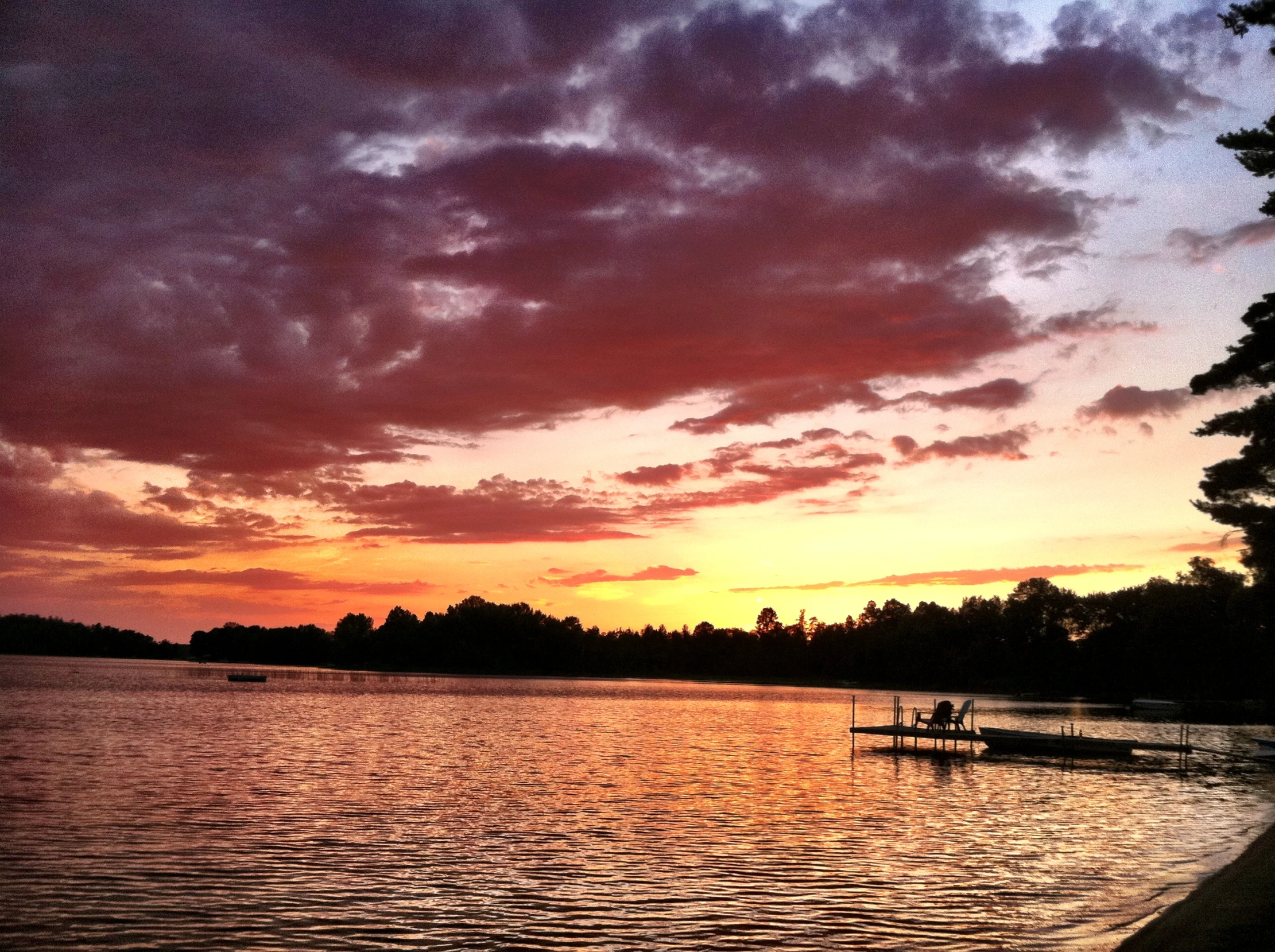 the clouds hang low over the water as sun sets