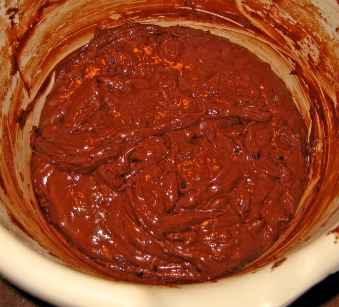 a bowl full of melted chocolate and brown substance