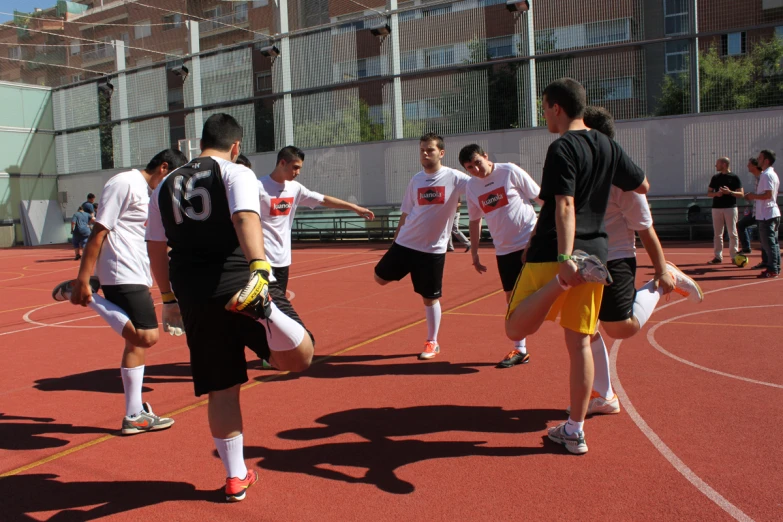 young men practice their moves on the basketball court