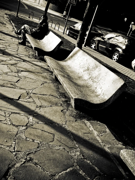 a man sitting on top of a wooden skateboard ramp