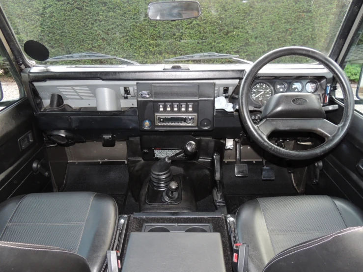 this is a black car with its dashboard and steering wheel