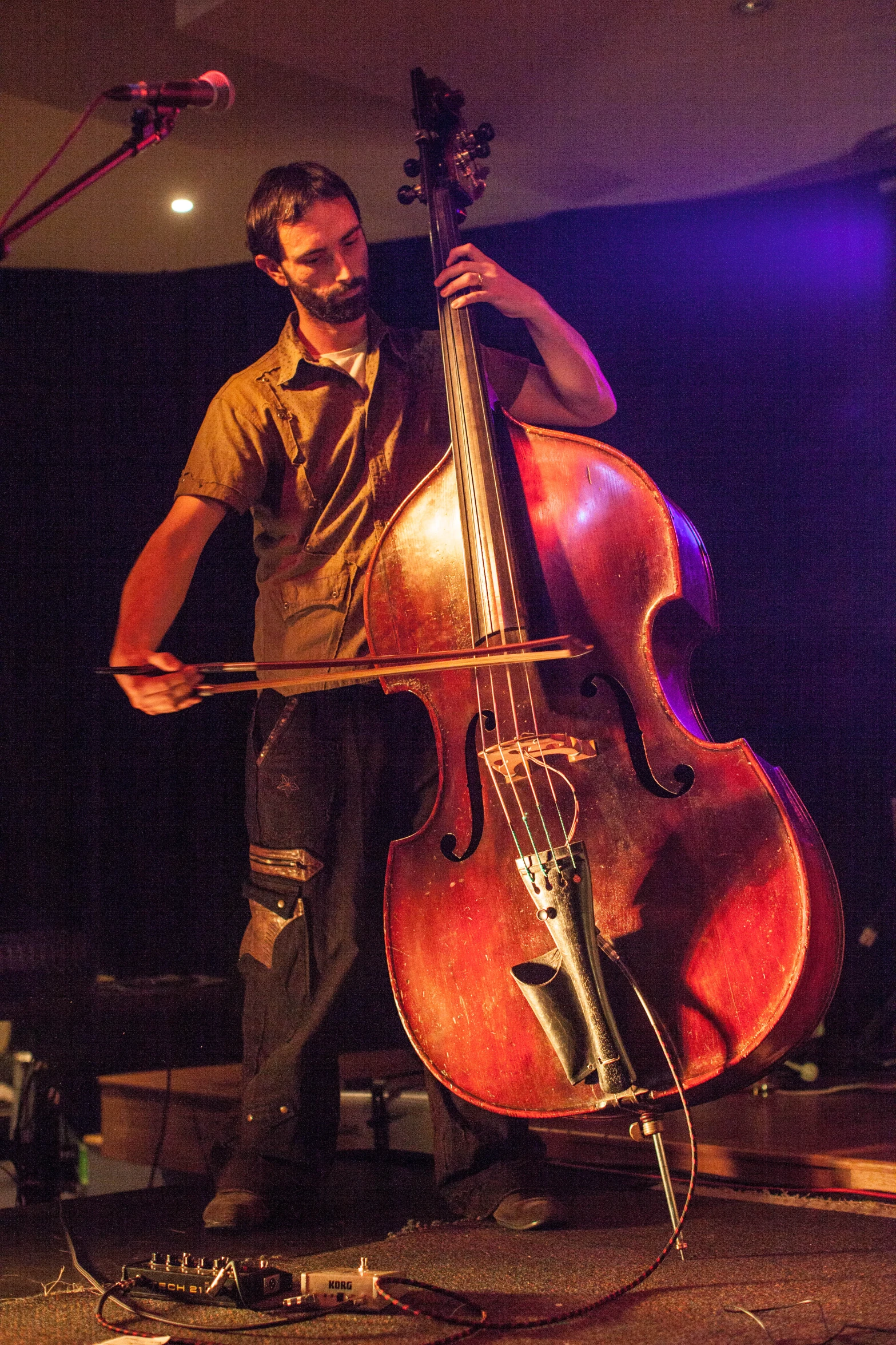 a man that is standing up playing a cello