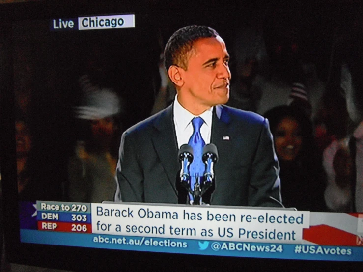 a tv screen shows the president giving a speech