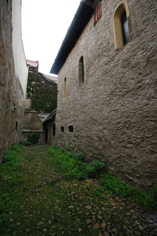 old cobblestone buildings with a clock tower on one side