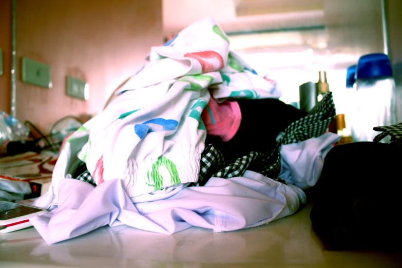 a man wearing a black top hiding under a blanket